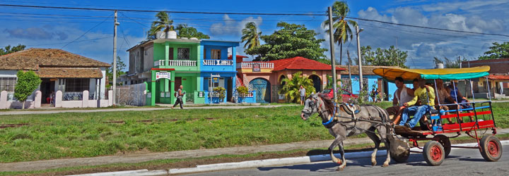 On main street calle Real, the cart passes while the horse huffs and puffs : Cuban animal protection programs are  file 13 © sogestour •[• Playa Ancon with the Sierra del Escambray in background © sogestour